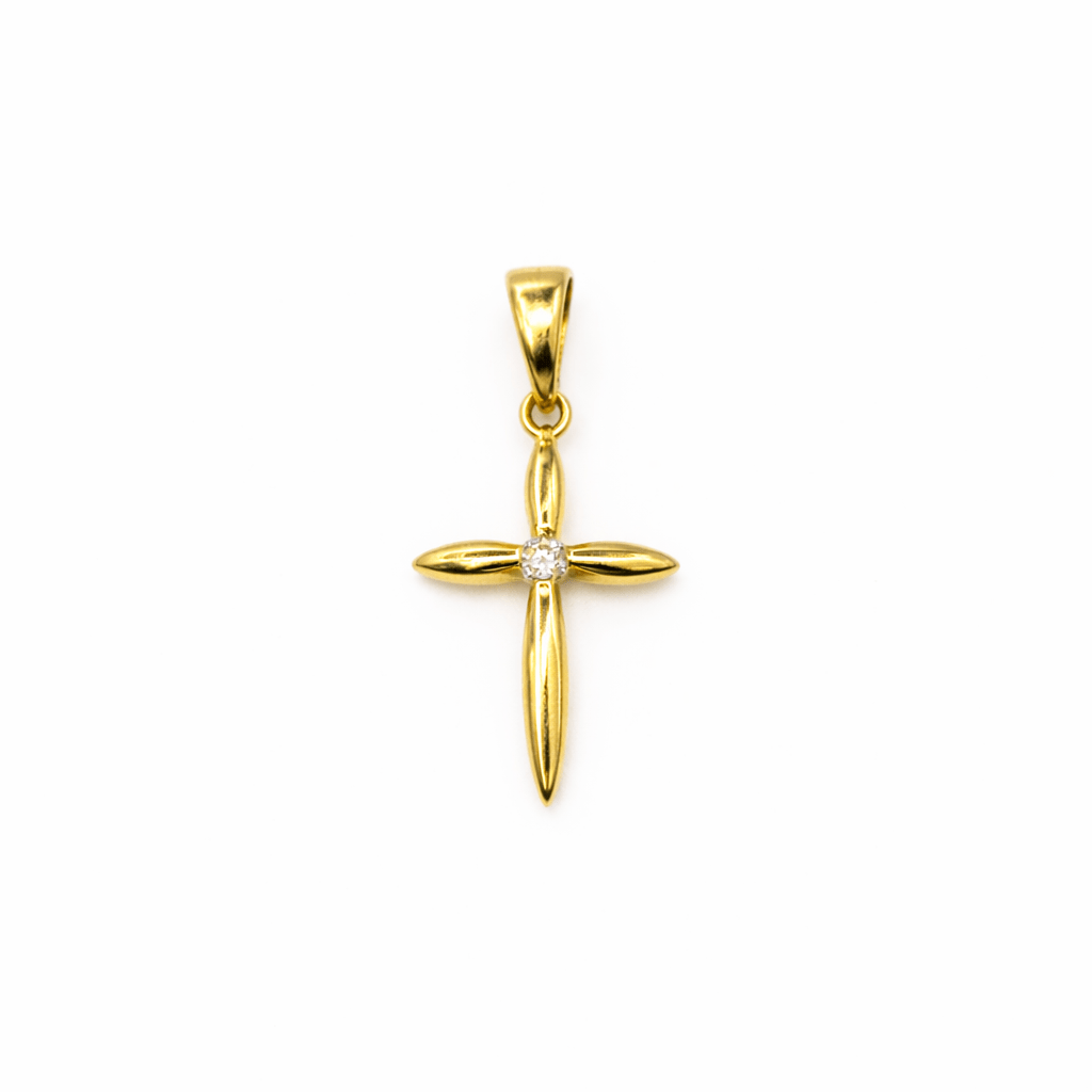 Hängsmycke kors i 18k guld. Litet stilrent kors med en gnistande cubic zirkonia kristall i mitten.
