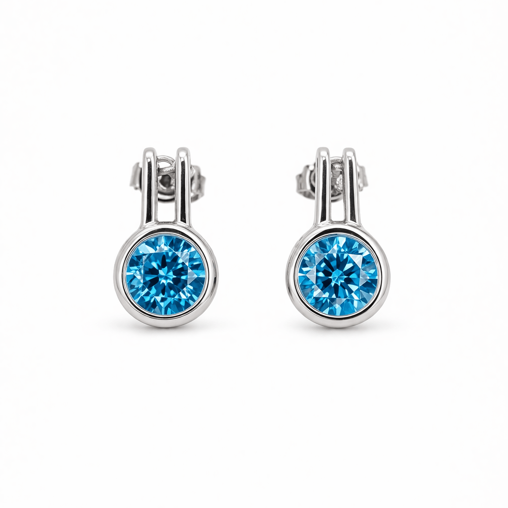 Örhängen i sterling silver. En turkos cubic zirkonia kristall nertill.